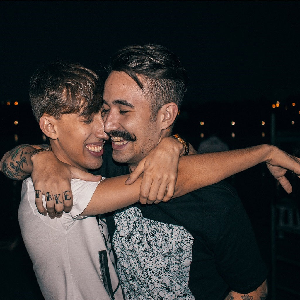 happy same sex male couple laughing and smiling together