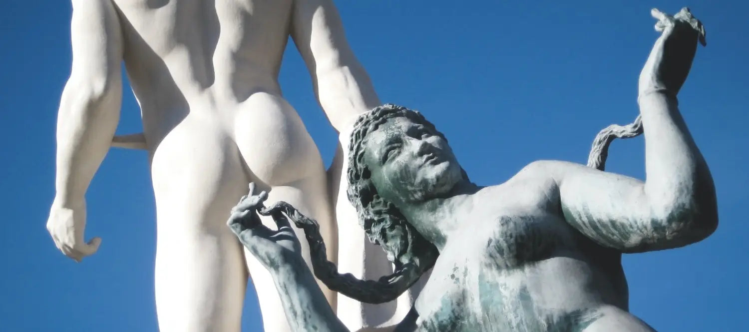 Two Statues one pointing at a bum