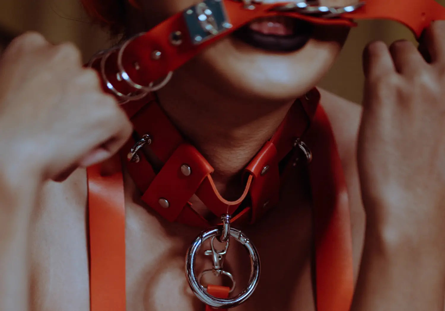 Woman biting red leather restraint Photo by Kamaji Ogino from Pexels